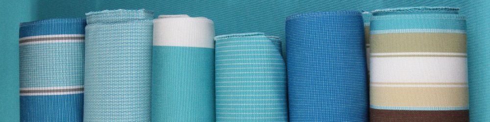 Six rolls of Tempotest Home Upholstery Fabric in blue solids and stripes